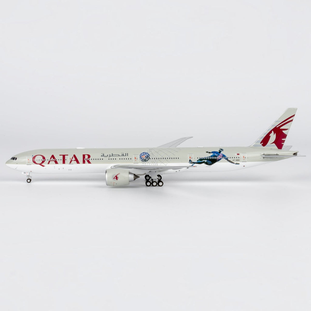 Slice 1:400 scale diecast Boeing 777-300ER model in Qatar Airways Paris Saint Germain livery on a white background