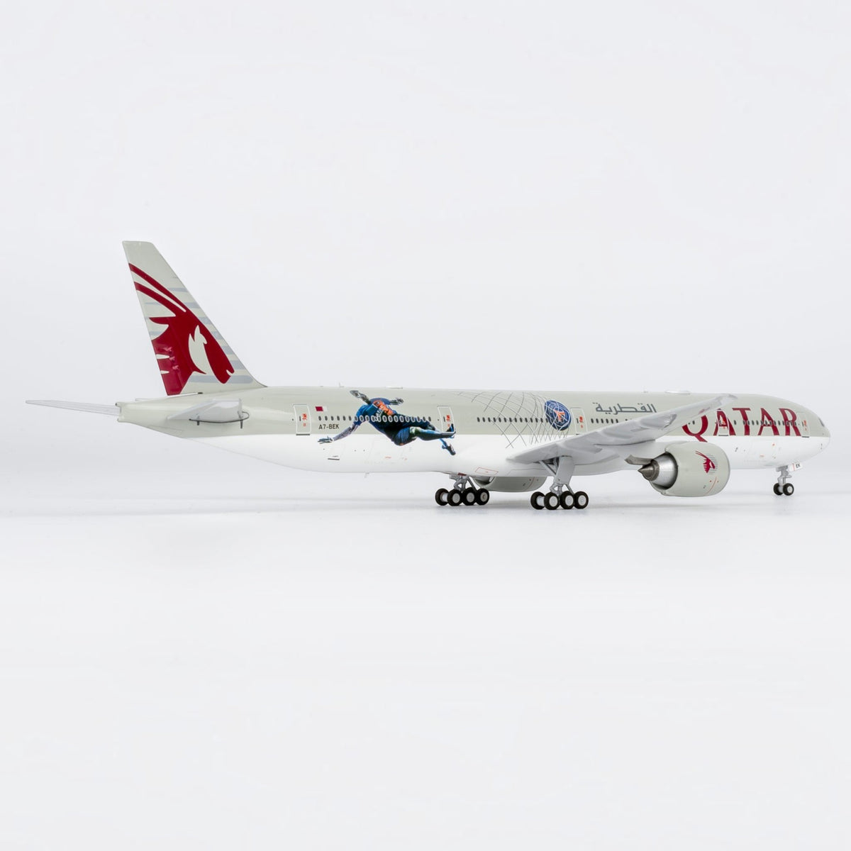 Slice 1:400 scale diecast Boeing 777-300ER model in Qatar Airways Paris Saint Germain livery on white background