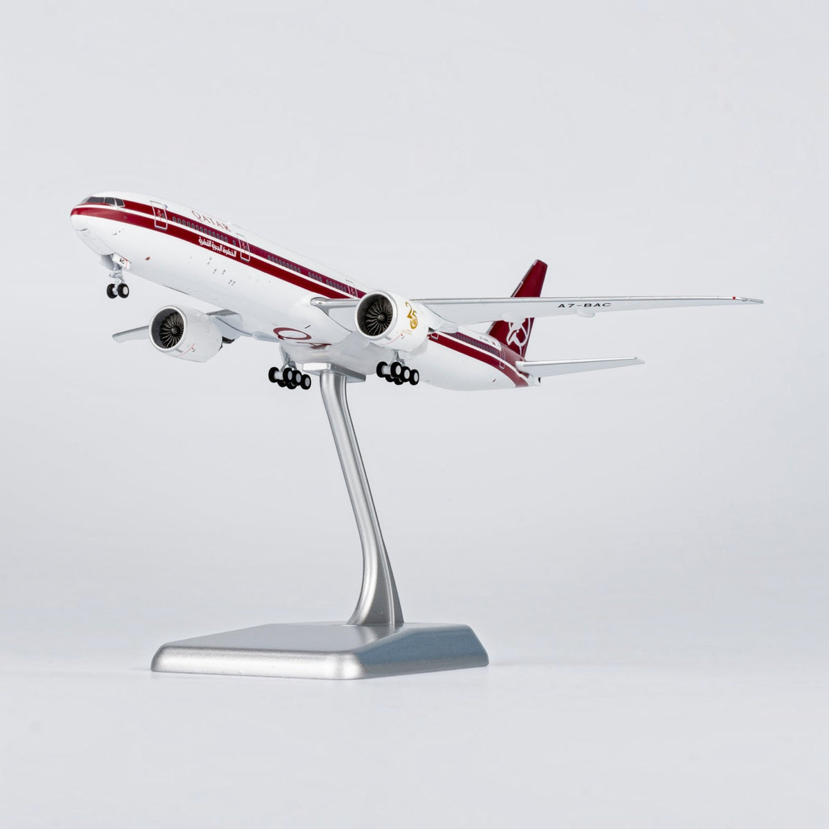 Slice Boeing 777-300ER Qatar Airways 25 years retro livery diecast model aircraft on a silver display stand