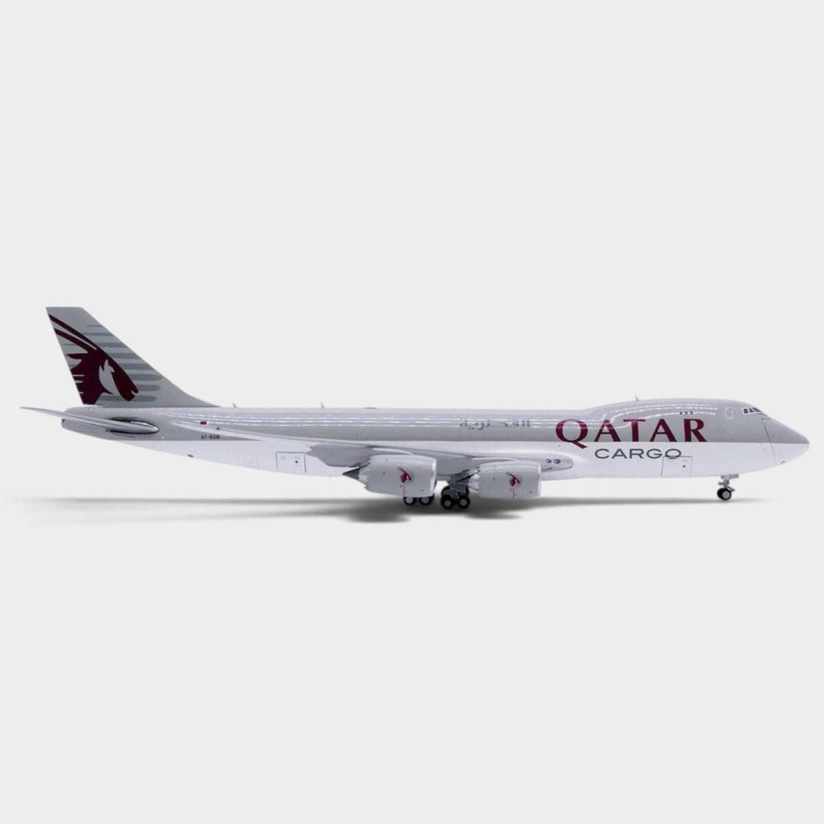 Slice JC Wings 1:400 scale diecast Boeing 747-8F Qatar Airways Cargo model plane in side profile view.