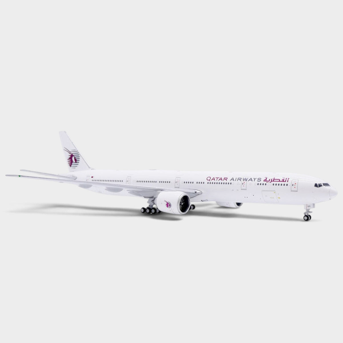 Slice 1:400 scale diecast model of a Qatar Airways Boeing 777-300ER in an all-white livery with landing gear.