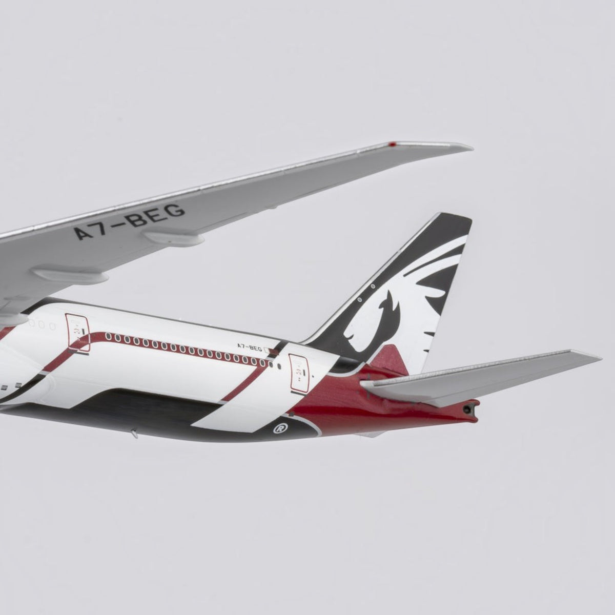 Slice Qatar Airways Boeing 777-300ER die-cast model airplane tail section with Formula 1 livery in burgundy and black