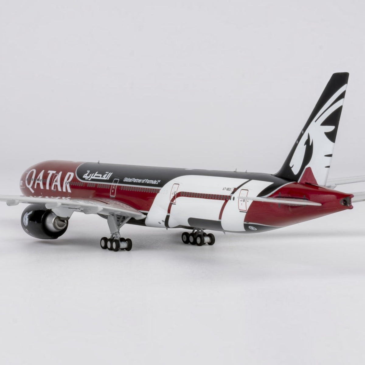 Slice 1:400 scale die-cast Qatar Airways Boeing 777-300ER model airplane in Formula 1 livery with burgundy and black