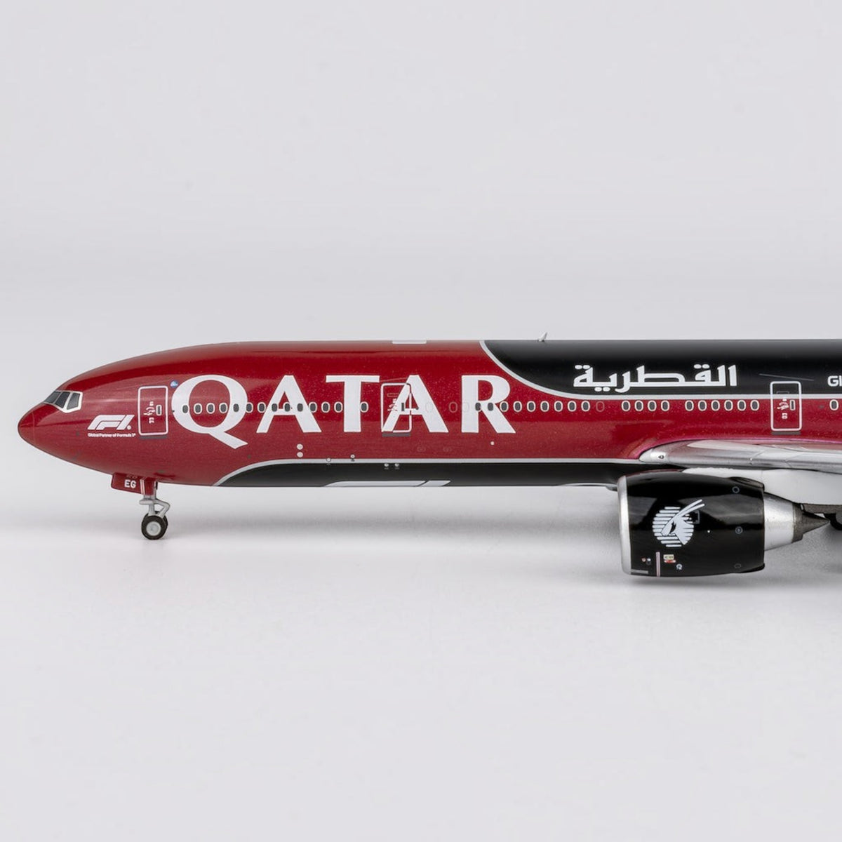 Slice Qatar Airways Boeing 777-300ER die-cast model airplane in burgundy and black Formula 1 livery side view