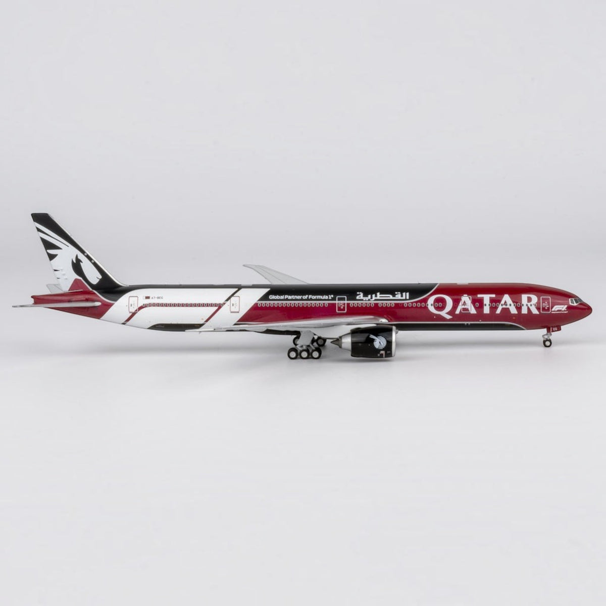 Slice Qatar Airways Boeing 777-300ER die-cast model airplane in Formula 1 livery with burgundy and black details.