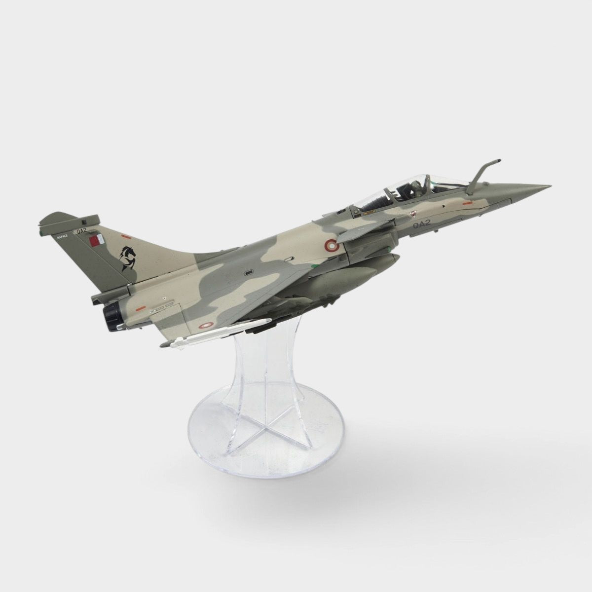 Slice 1:72 scale diecast Rafale EQ model of the Qatar Emiri Air Force fighter jet displayed on a clear plastic stand